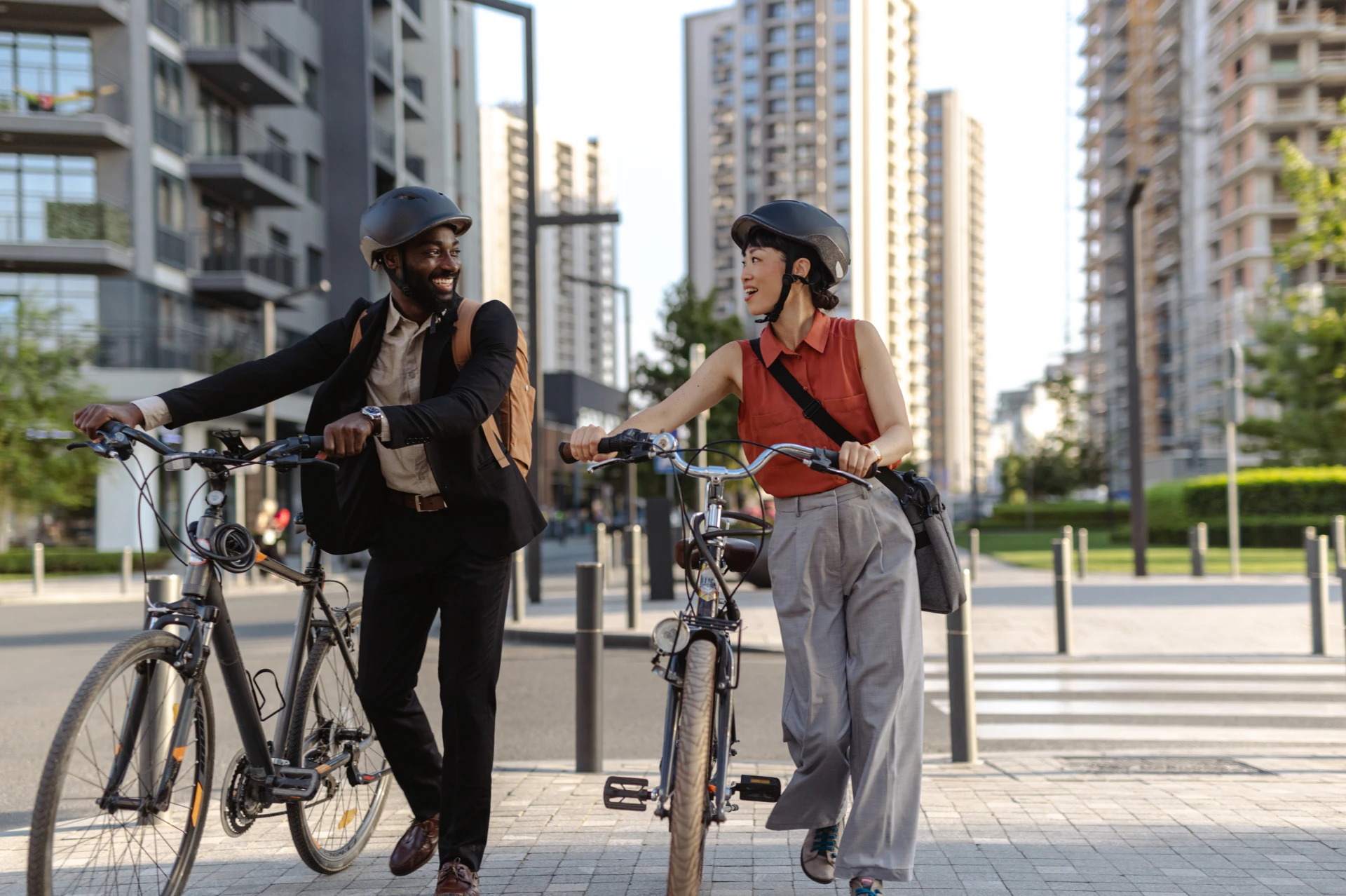 two people with bicycles walking